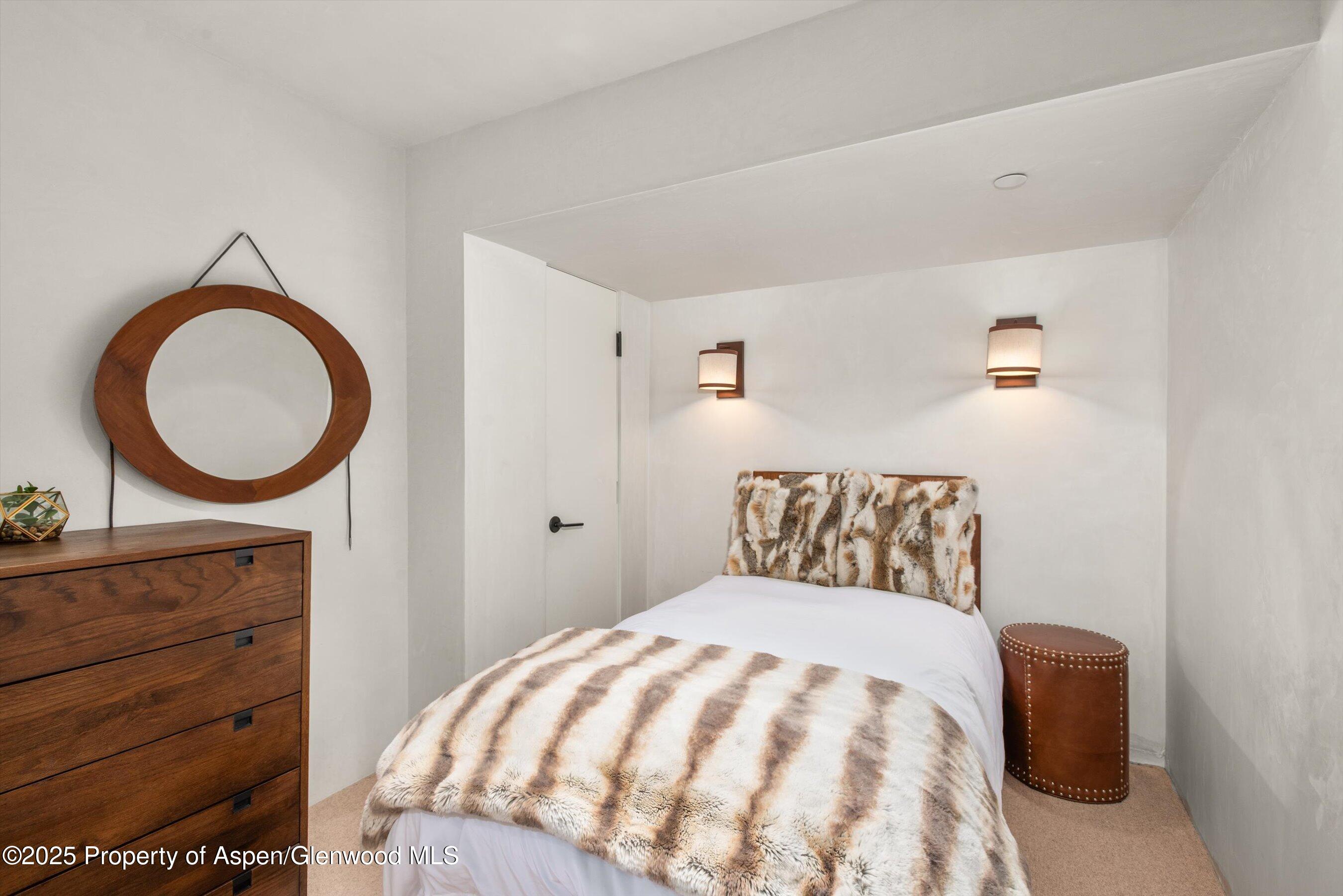 706 East Hyman Avenue, Unit 706 Aspen, CO 81611 - Photo 37 of 46 a bedroom with a bed and a dresser