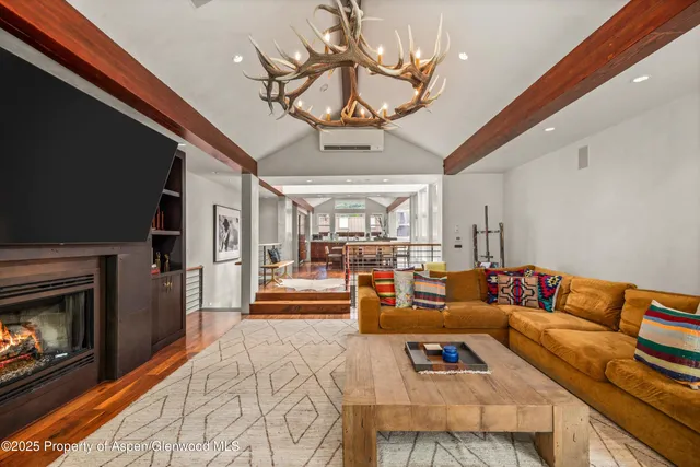 a room with lots of furniture and a large window