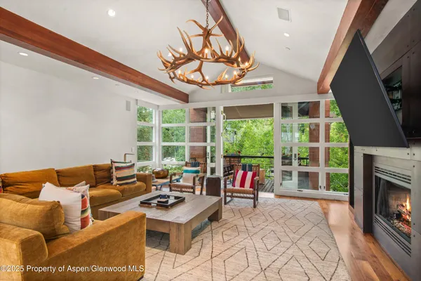 a living room with lots of furniture and large windows