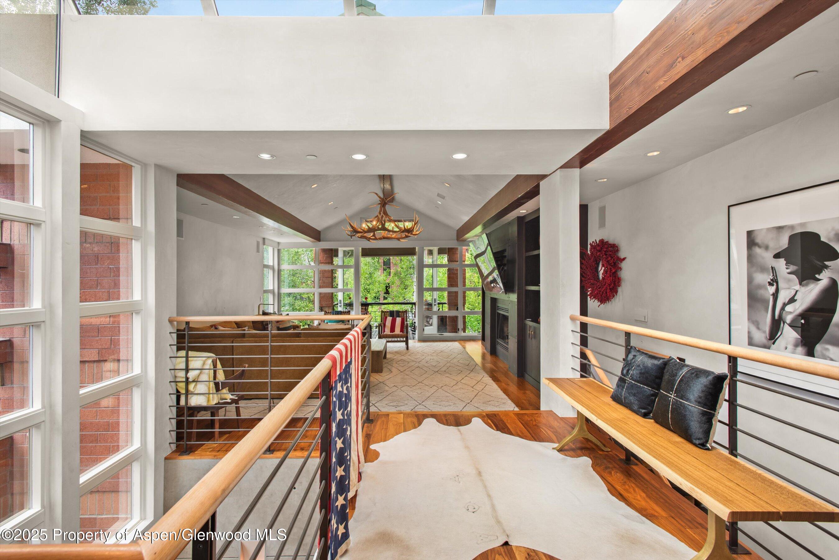 706 East Hyman Avenue, Unit 706 Aspen, CO 81611 - Photo 10 of 46 a room with lots of furniture and a large window