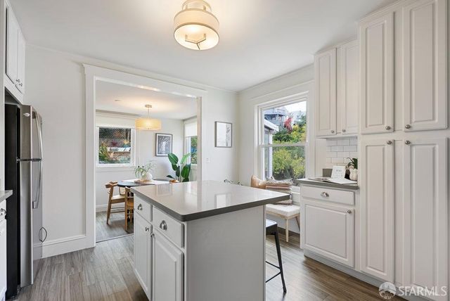 a kitchen with a sink stove and wooden floor