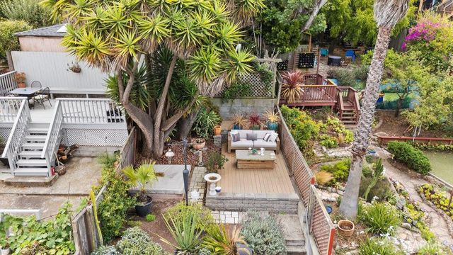 an aerial view of a house with swimming pool garden and patio