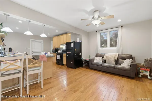 a living room with furniture and kitchen view