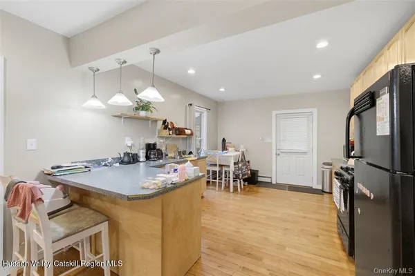 a kitchen with a refrigerator and a stove top oven