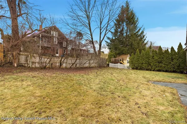 a view of a yard with a large tree