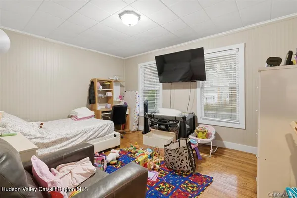 a bedroom with furniture and a flat screen tv