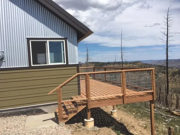 a view of a balcony with yard