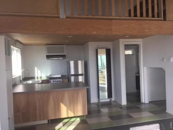a view of a kitchen from the hallway