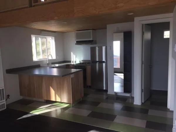 a kitchen with refrigerator and window