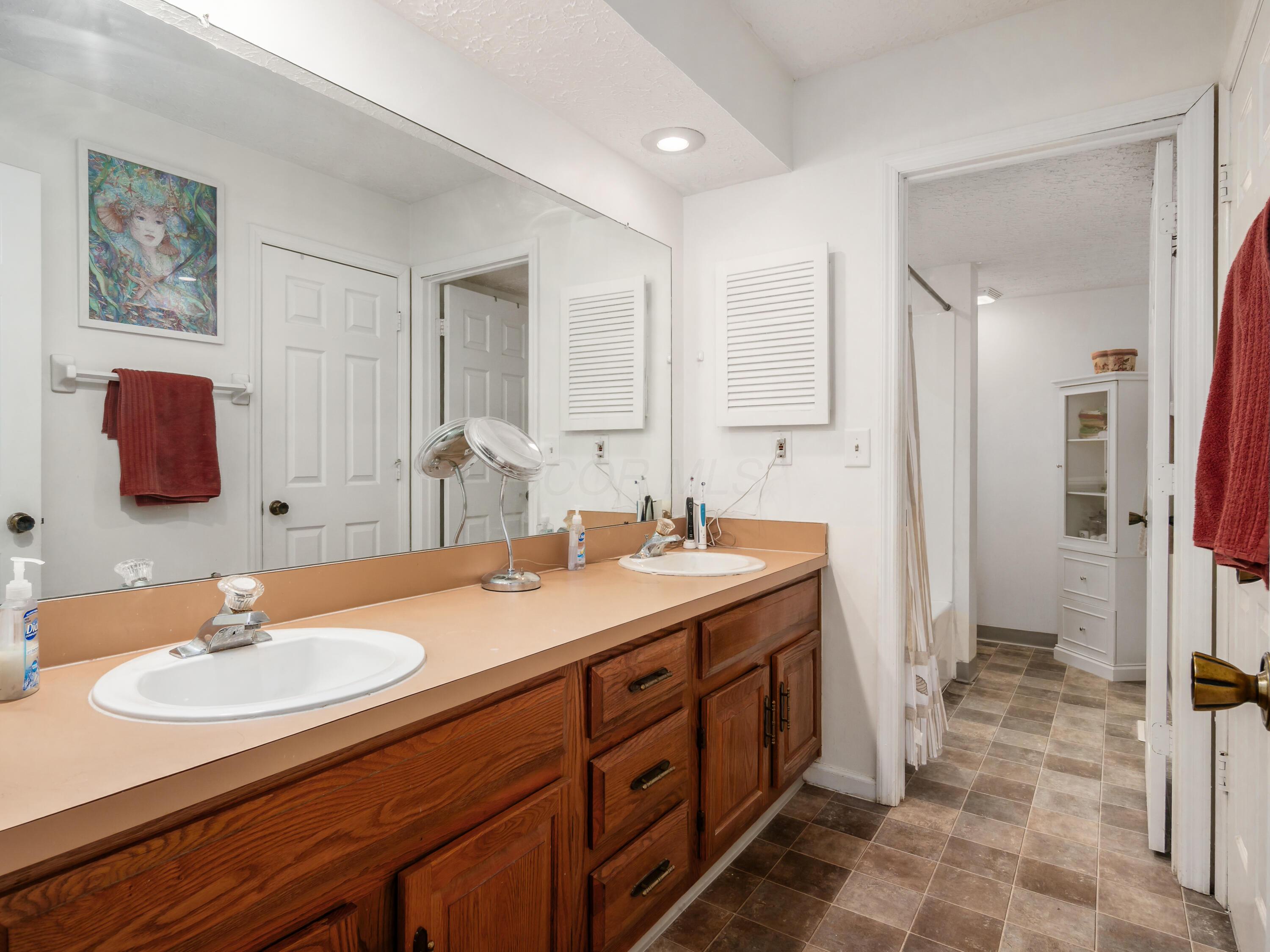 7004 Avery Road Dublin, OH 43017 - Photo 22 of 31 There is a door separating the vanity area, from the shower/bath area.