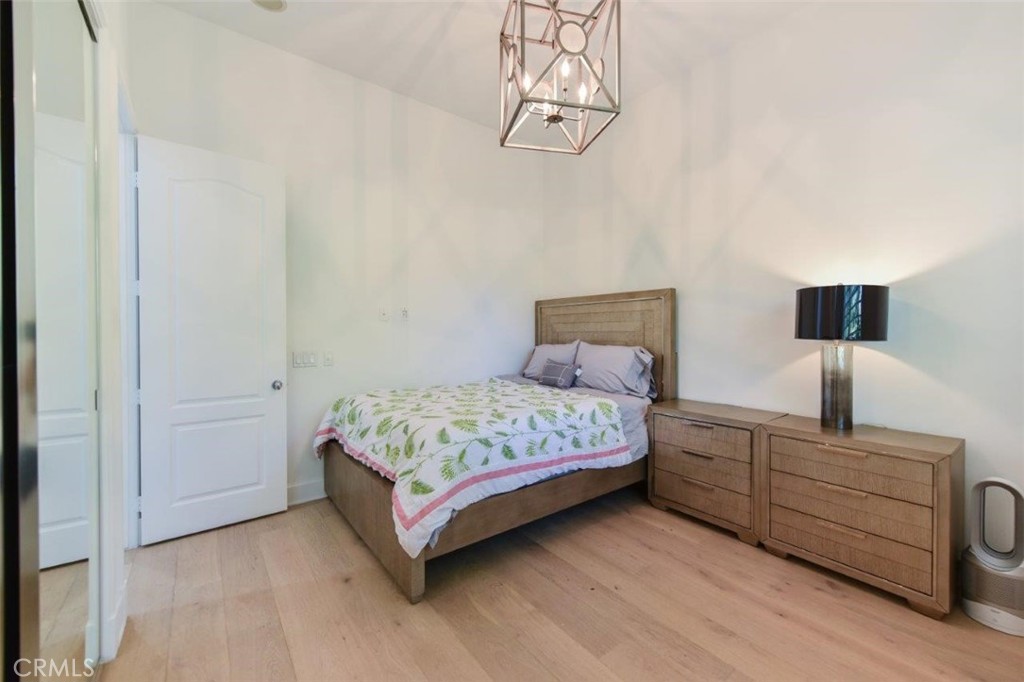 7 Via Brezza Newport Coast, CA 92657 - Photo 38 of 75 a bedroom with a bed and chandelier