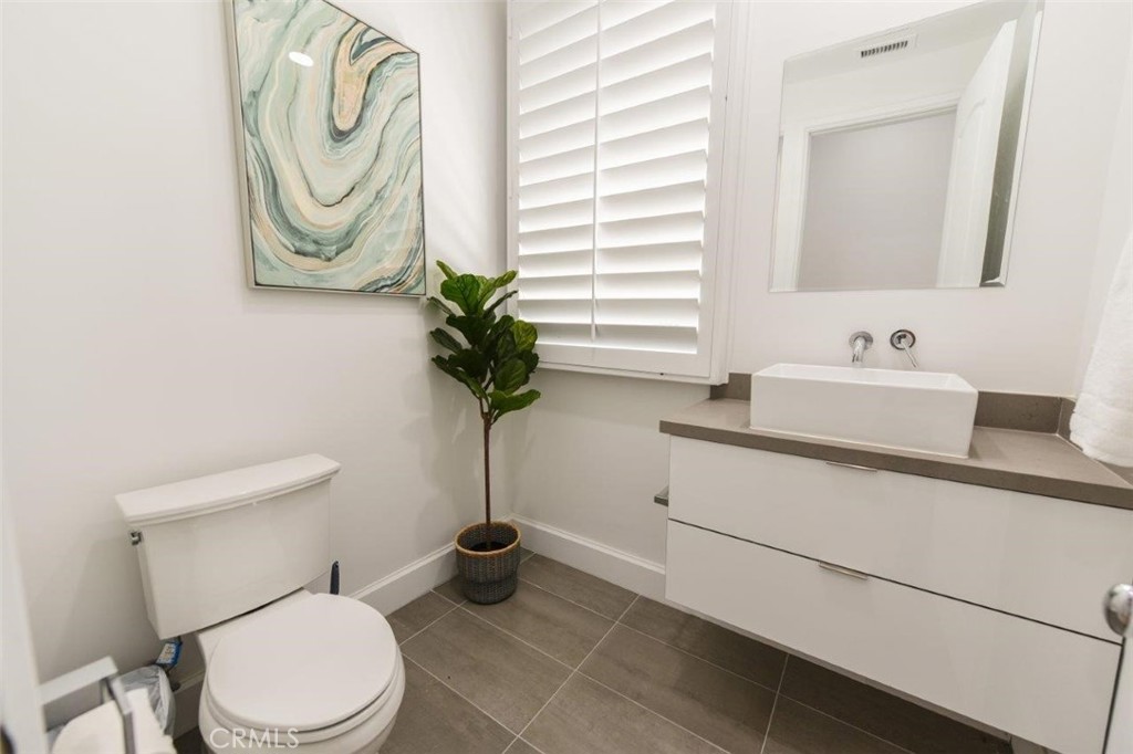 7 Via Brezza Newport Coast, CA 92657 - Photo 5 of 75 a white toilet sitting next to a bathroom sink