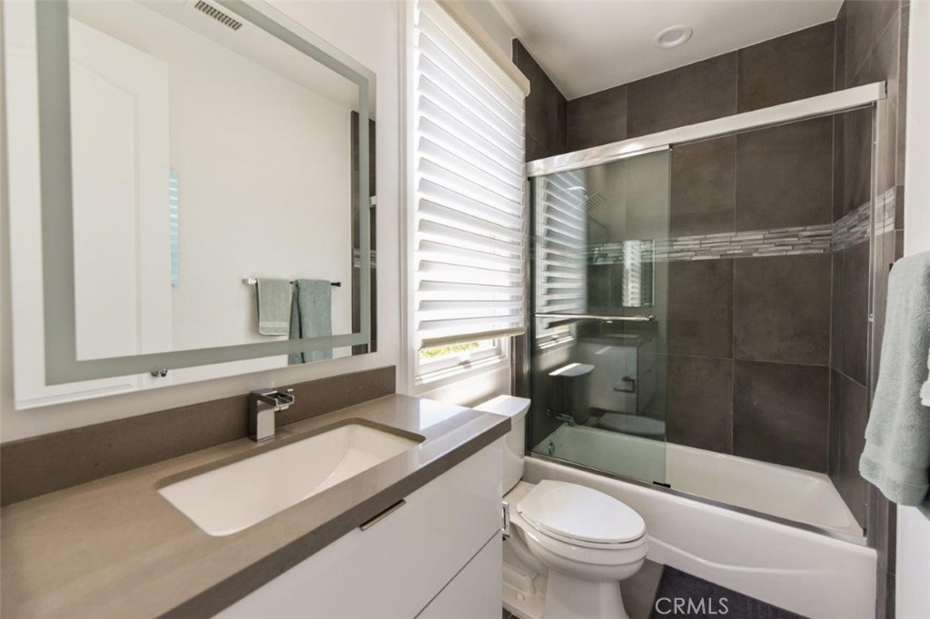 7 Via Brezza Newport Coast, CA 92657 - Photo 73 of 75 a bathroom with a sink a toilet a mirror and shower
