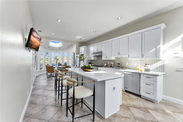 a kitchen with a sink stove and white cabinets