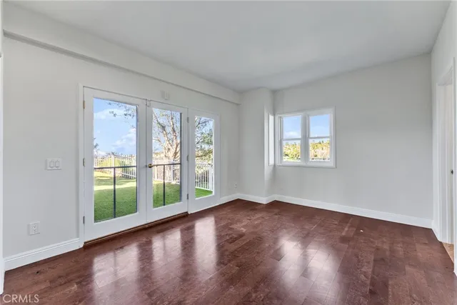 a view of staircase with lots of frames on wall and a large window