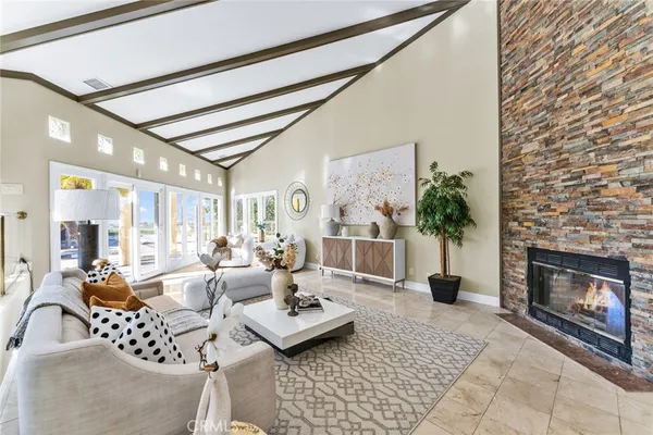 a living room with furniture a chandelier and a potted plant