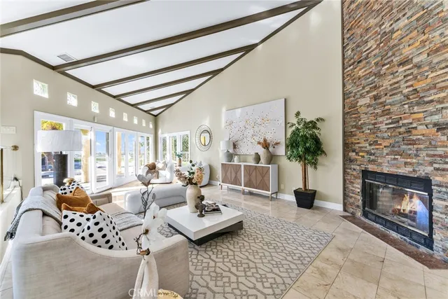 a living room with furniture a chandelier and a potted plant
