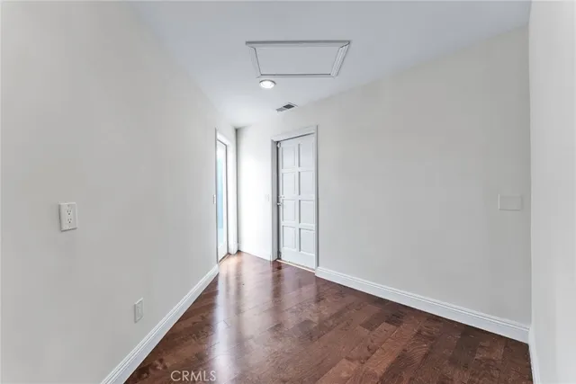 a living room with furniture potted plant and a wooden floor