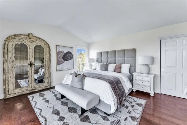 a large white kitchen with cabinets and a window