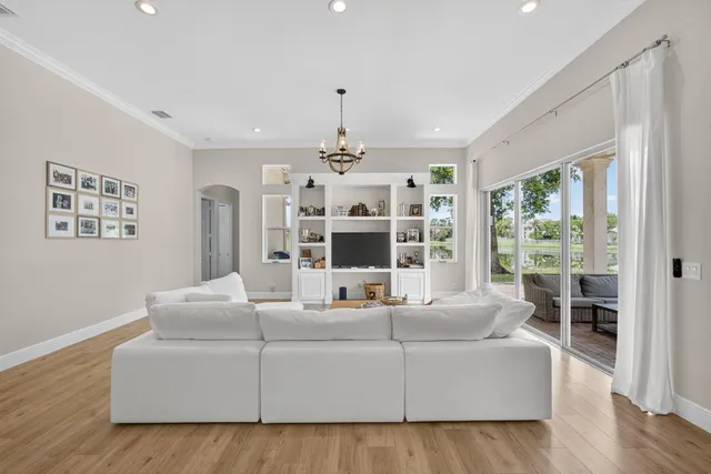 a kitchen with counter top space sink stove and wooden floor