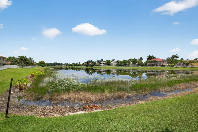 a view of a lake with houses in the back