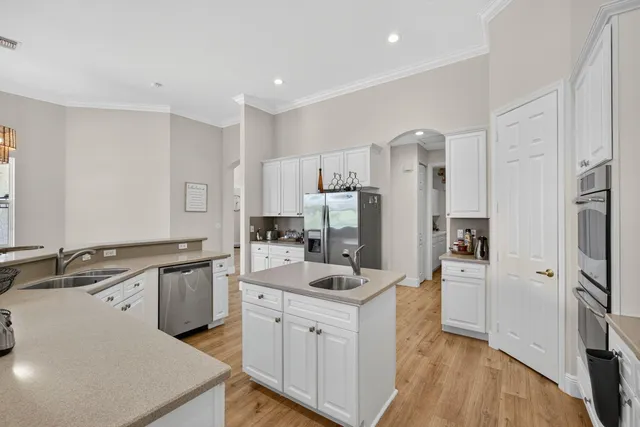 a dining room with furniture a chandelier and wooden floor