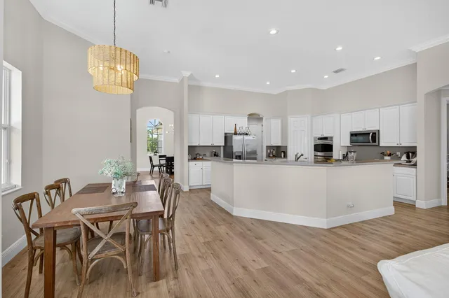a bedroom with a large bed and flat tv screen on dresser