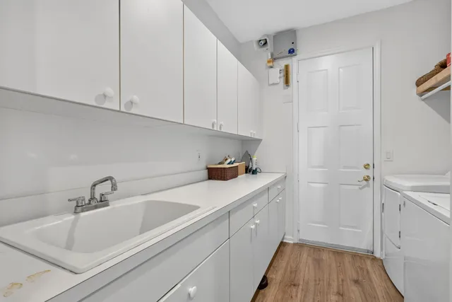 a spacious bathroom with a tub sink shower and mirror