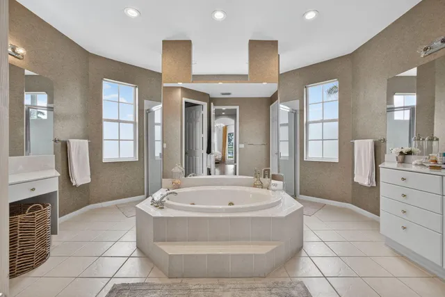 a en suite bathroom with a sink and mirror with toilet