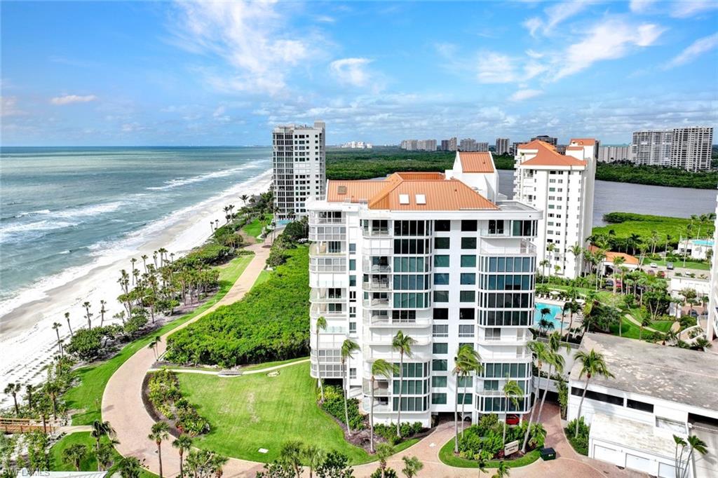 20 Seagate Drive, Unit 1102 Naples, FL 34103 - Photo 30 of 40 a view of a large building with a yard