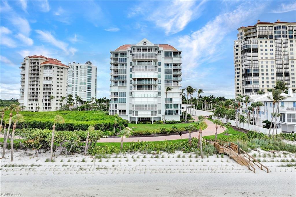 20 Seagate Drive, Unit 1102 Naples, FL 34103 - Photo 34 of 40 a large building with a garden and plants