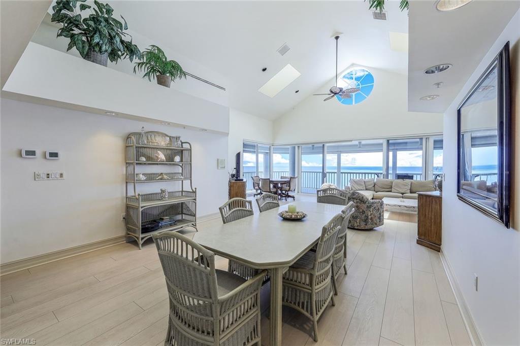 20 Seagate Drive, Unit 1102 Naples, FL 34103 - Photo 6 of 40 a dining room with furniture and a floor to ceiling window