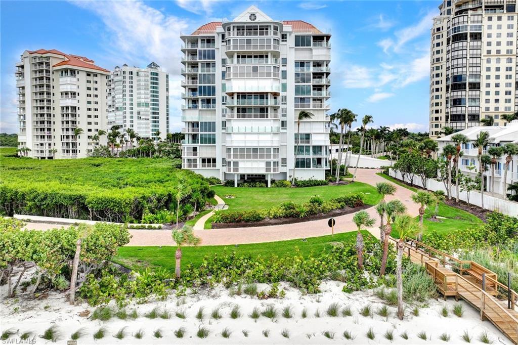 20 Seagate Drive, Unit 1102 Naples, FL 34103 - Photo 7 of 40 a view of a building with a garden and plants