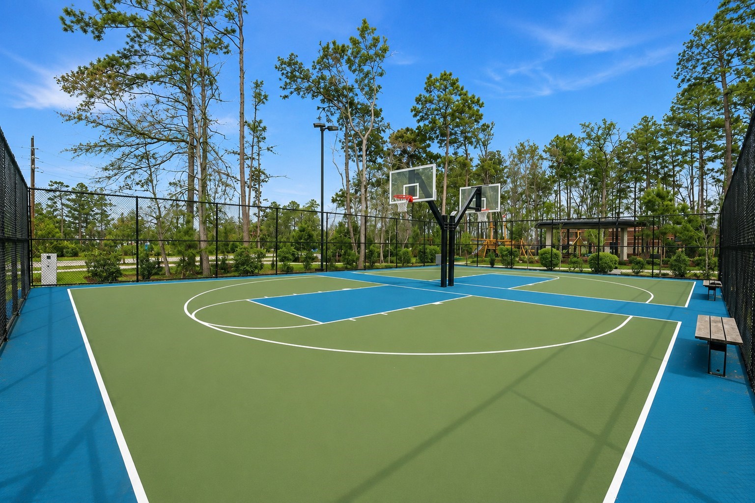 4022 Sabine Valley Trail Spring, TX 77386 - Photo 43 of 46 Well-maintained outdoor basketball court featuring dual hoops and a fenced setting surrounded by mature trees. A great community amenity for recreation, exercise, and outdoor enjoyment.