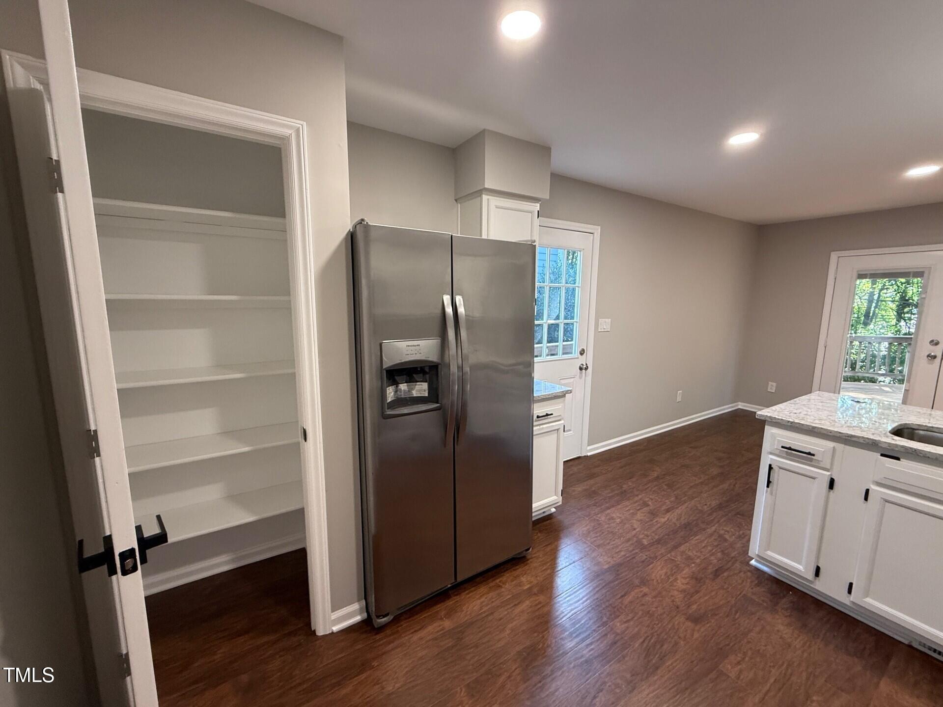 8316 Bellingham Circle Raleigh, NC 27615 - Photo 11 of 22 a kitchen with a refrigerator and a stove top oven