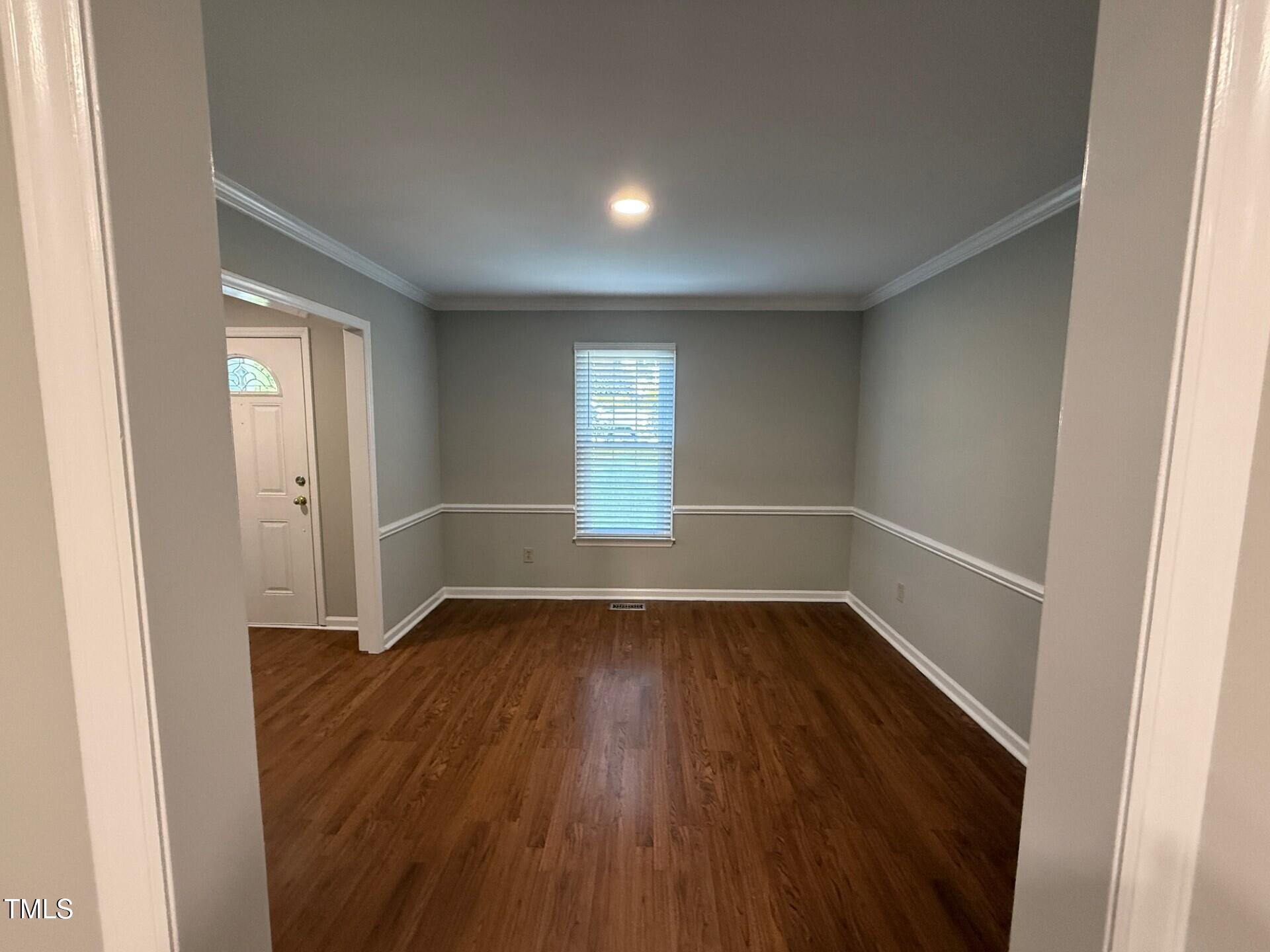 8316 Bellingham Circle Raleigh, NC 27615 - Photo 12 of 22 an empty room with wooden floor and windows