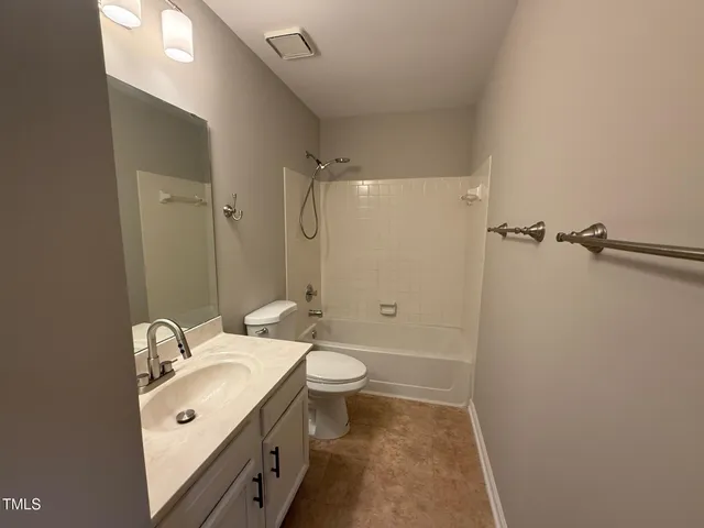 a bathroom with a double vanity sink toilet and shower