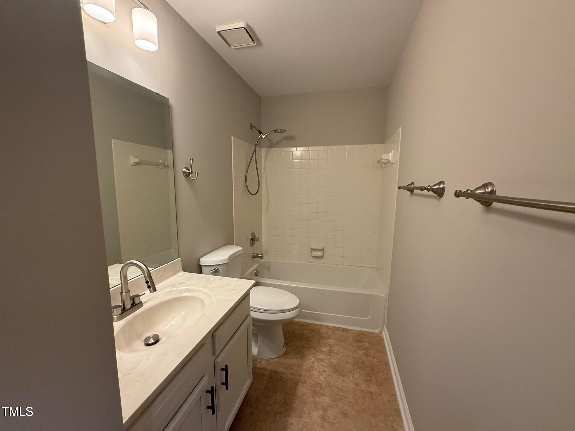 8316 Bellingham Circle Raleigh, NC 27615 - Photo 18 of 22 a bathroom with a double vanity sink toilet and shower