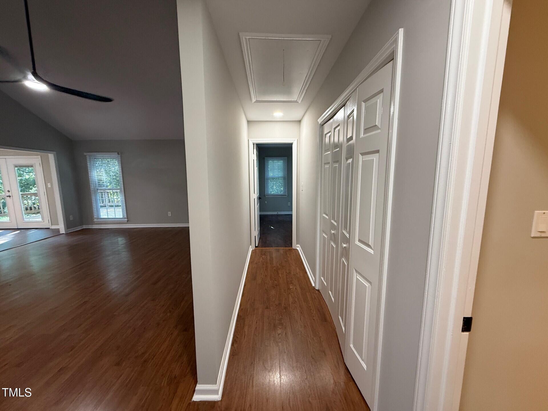 8316 Bellingham Circle Raleigh, NC 27615 - Photo 19 of 22 a view of a hallway with wooden floor and stairs