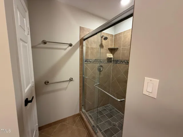 a bathroom with a glass shower door