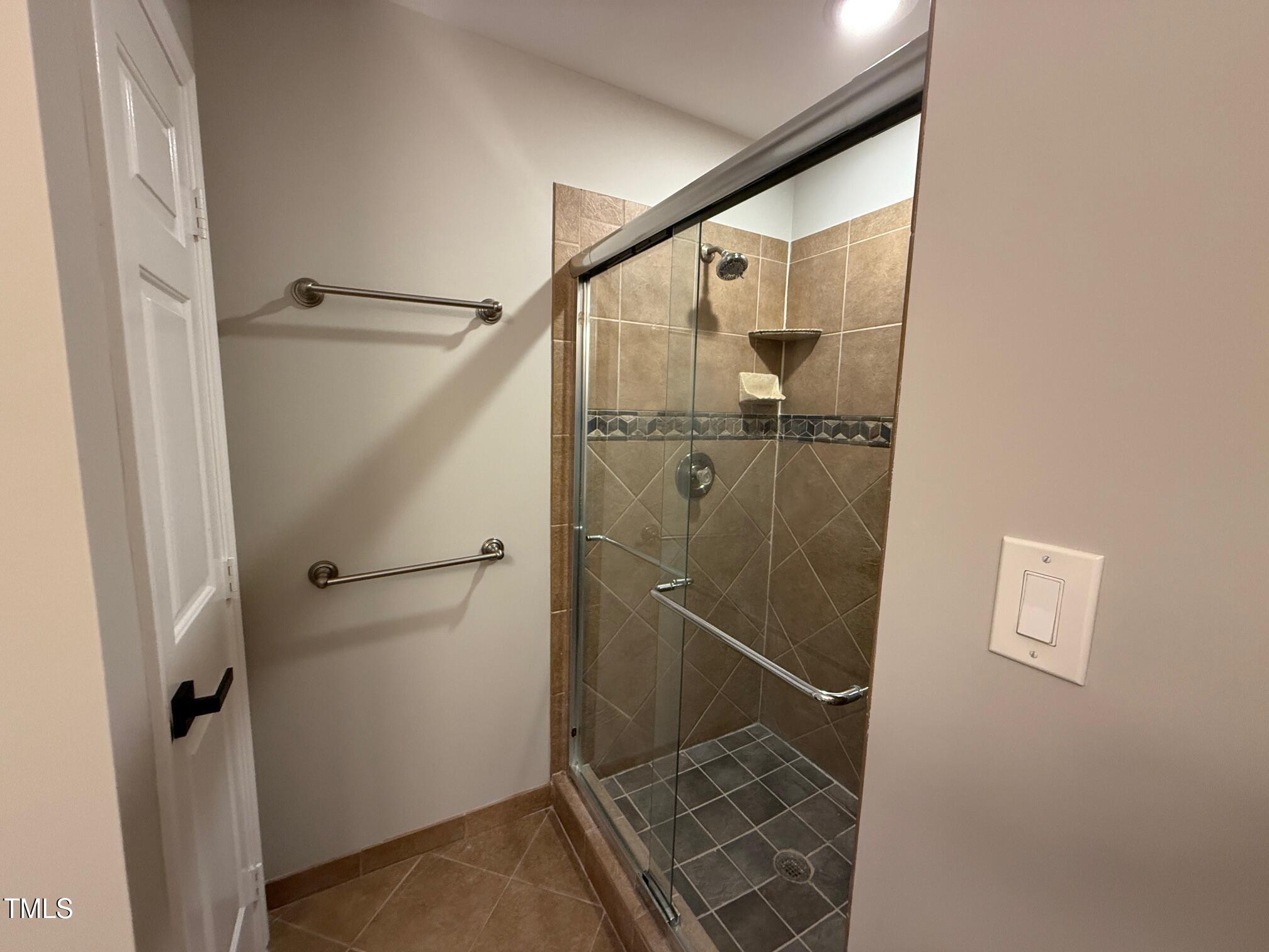 8316 Bellingham Circle Raleigh, NC 27615 - Photo 22 of 22 a bathroom with a glass shower door