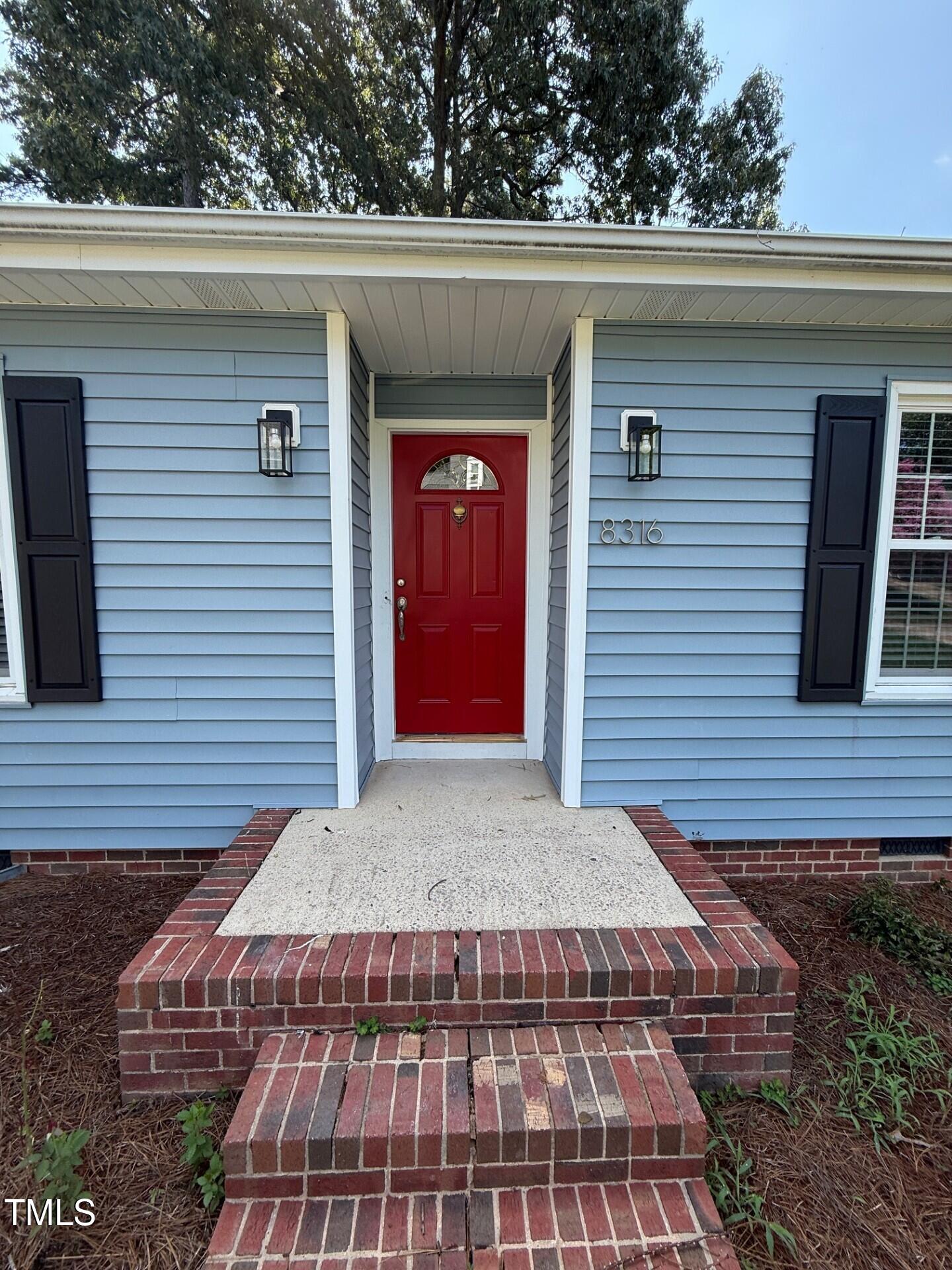 8316 Bellingham Circle Raleigh, NC 27615 - Photo 3 of 22 a front view of a house with a garden