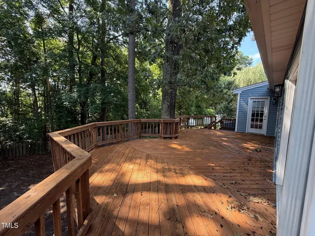 a view of balcony with deck and trees