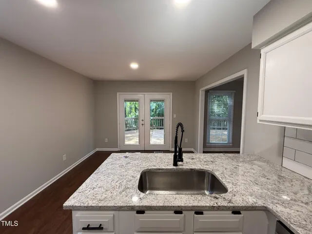 a kitchen with granite countertop a sink and a window