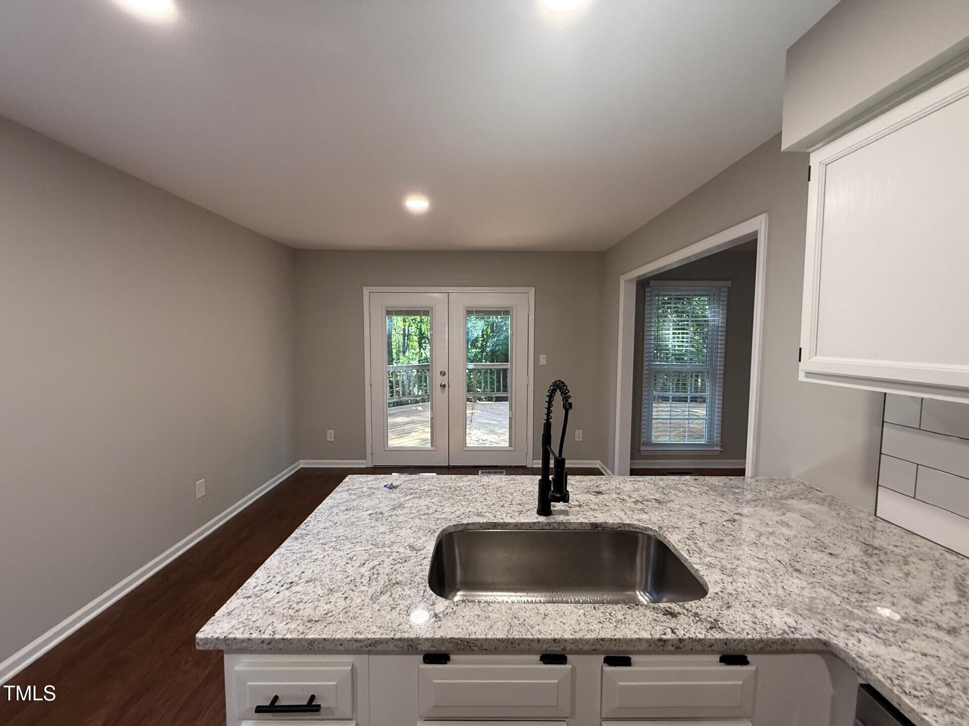 8316 Bellingham Circle Raleigh, NC 27615 - Photo 10 of 22 a kitchen with granite countertop a sink and a window