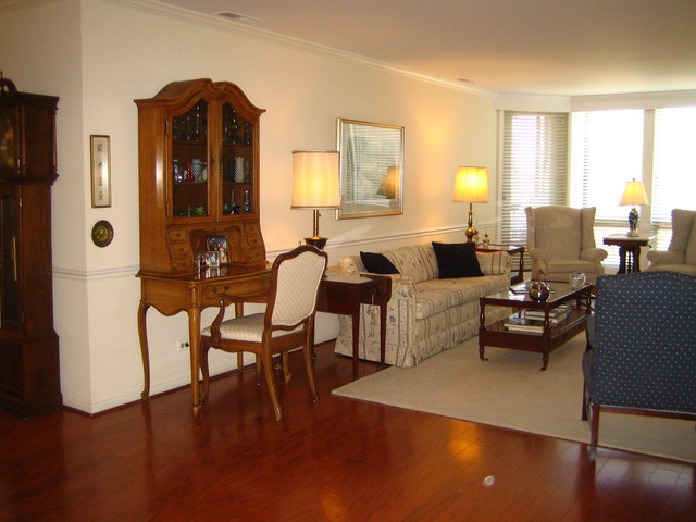 1140 Old Mill Road, Unit 504F Hinsdale, IL 60521 - Photo 3 of 21 a living room with furniture wooden floor and a lamp