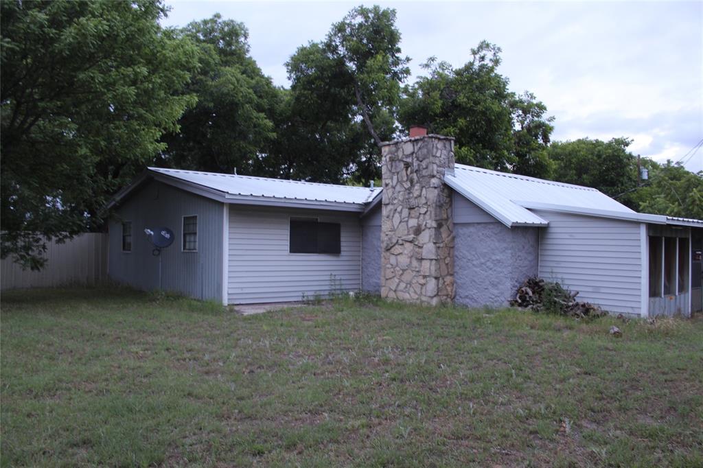 510 Hamby Road Clyde, TX 79510 - Photo 2 of 23 Exterior siding with a stone chimney feature and metal roofing