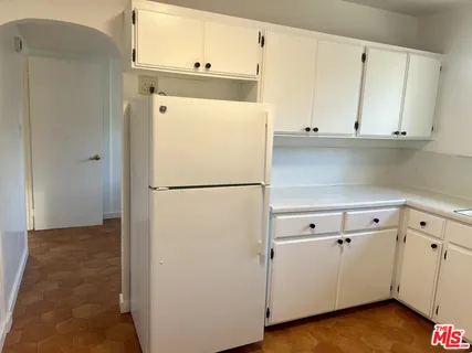 a white refrigerator freezer sitting inside of a kitchen