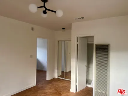 a white toilet sitting next to a shower