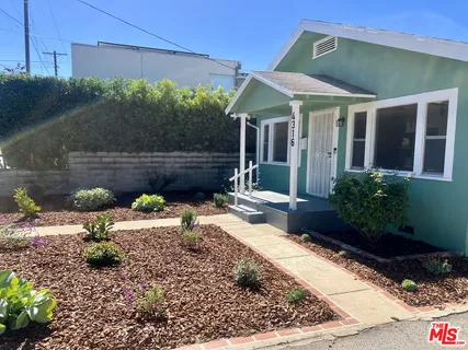 a view of a chair and table in backyard